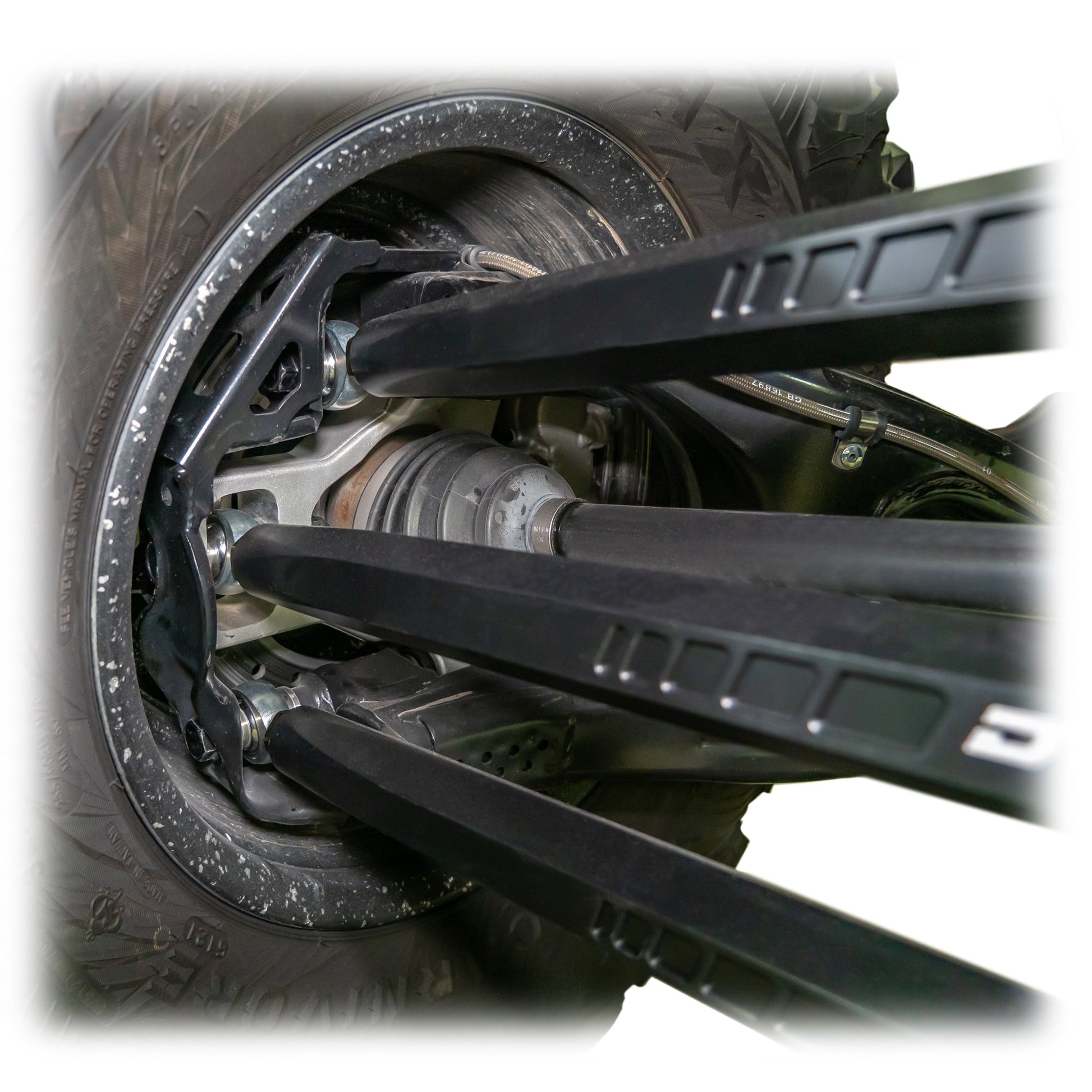 Installed barrel radius rod kit under rear control arm of Maverick X3 Wheel Close up