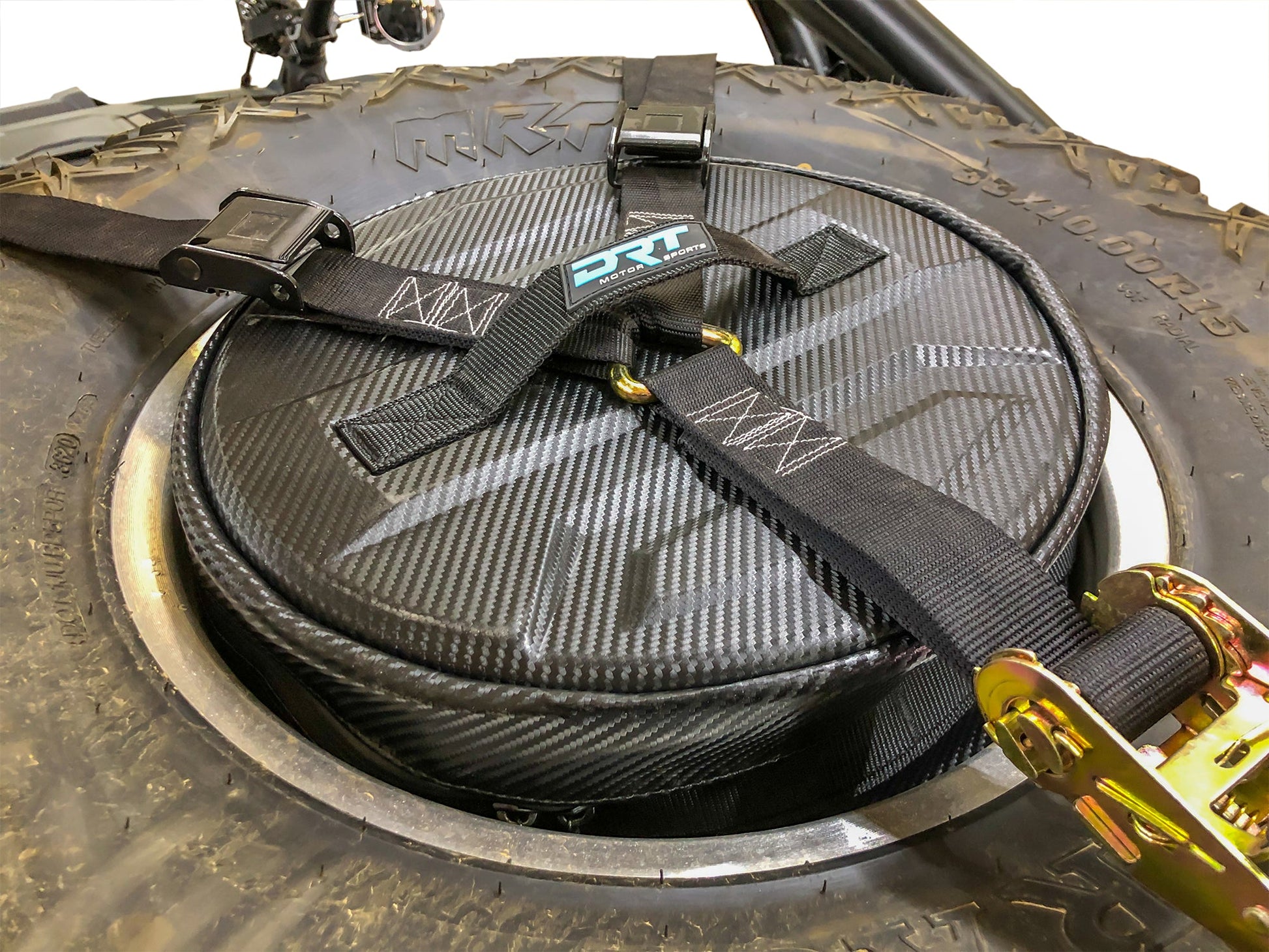 Spare tire storage bag sitting inside inverted off road wheel