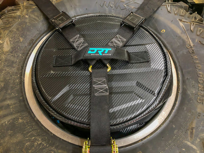 Spare tire storage bag sitting inside inverted off road wheel
