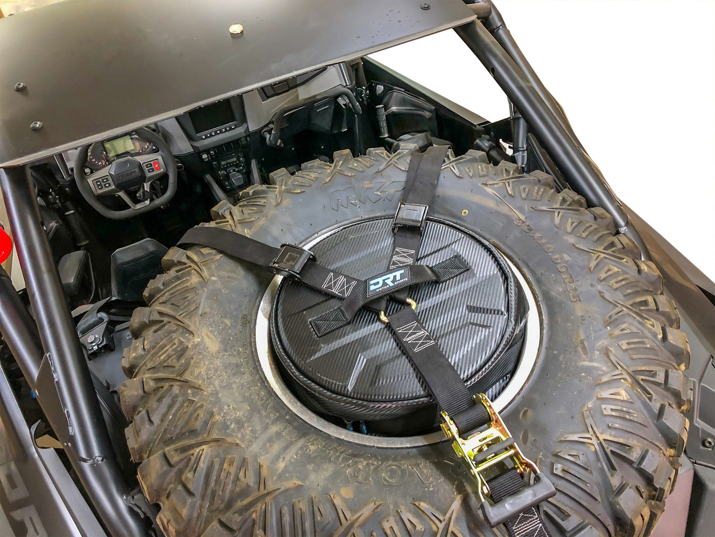 Spare tire storage bag sitting inside inverted off road wheel