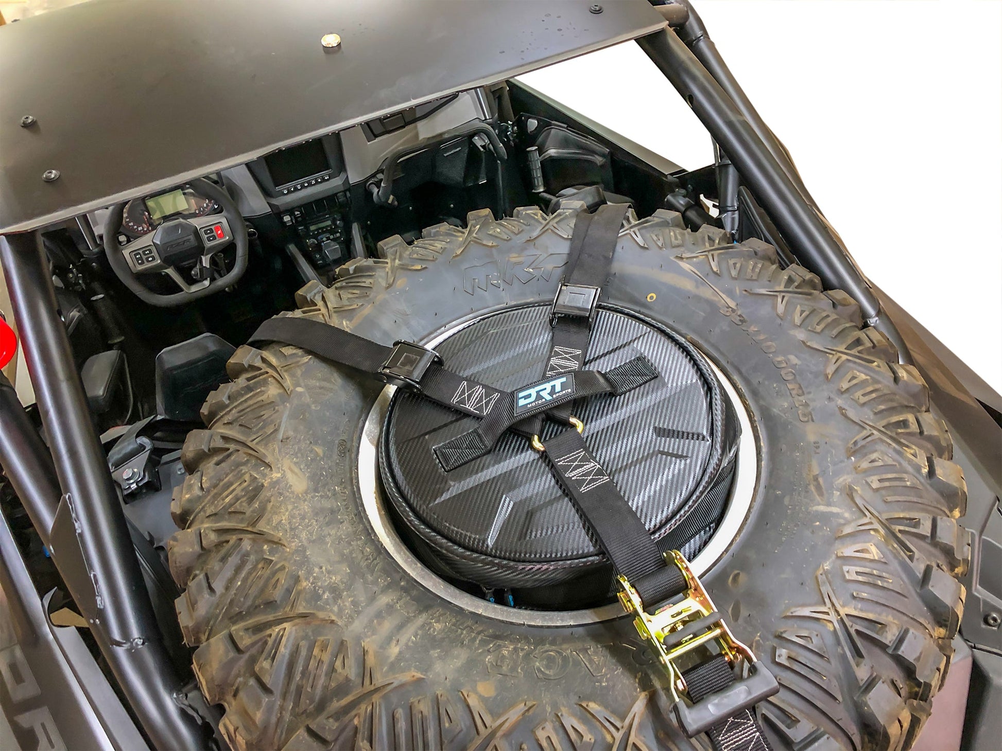 Spare tire storage bag sitting inside inverted off road wheel