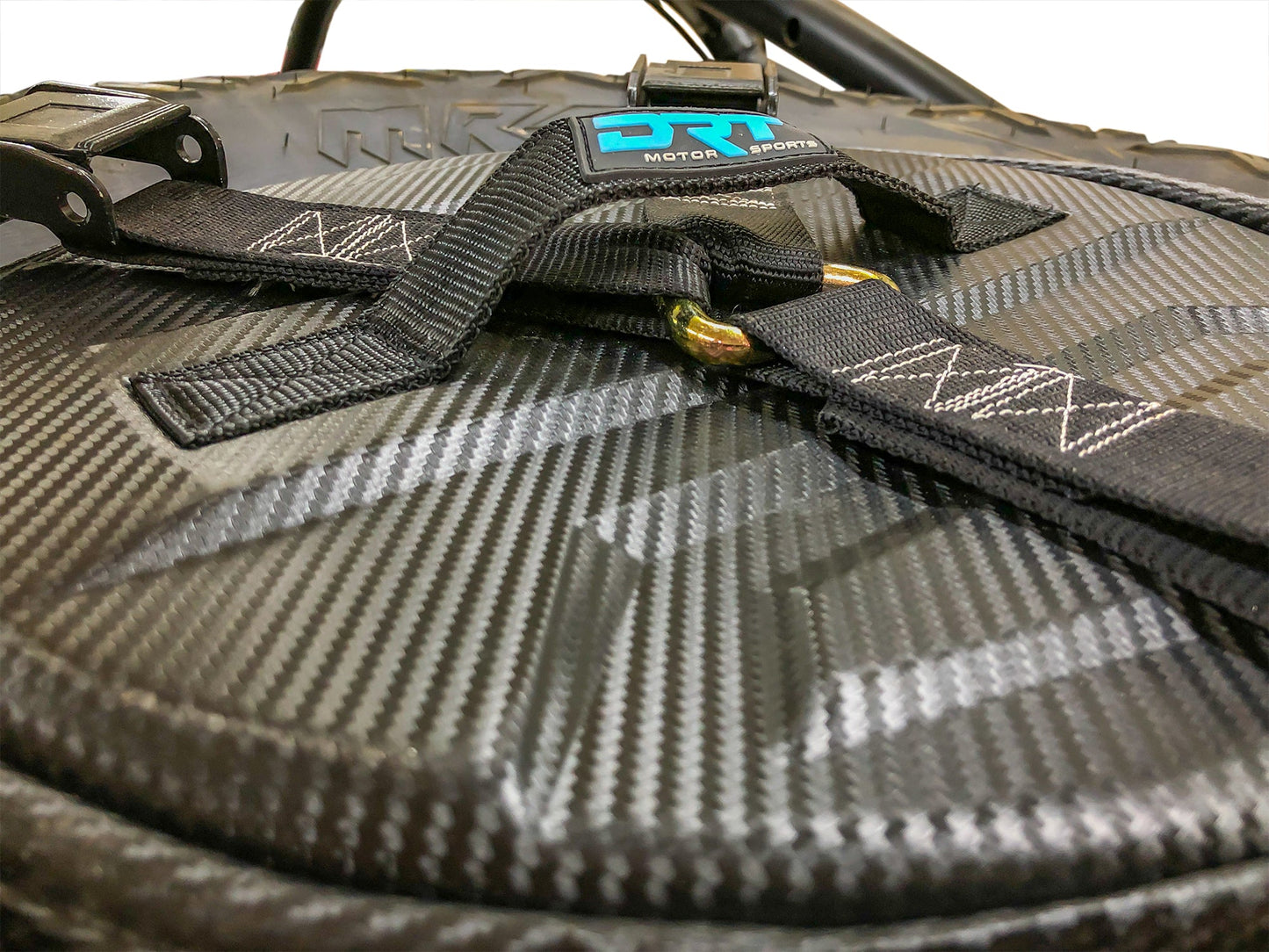 Spare tire storage bag sitting inside inverted off road wheel